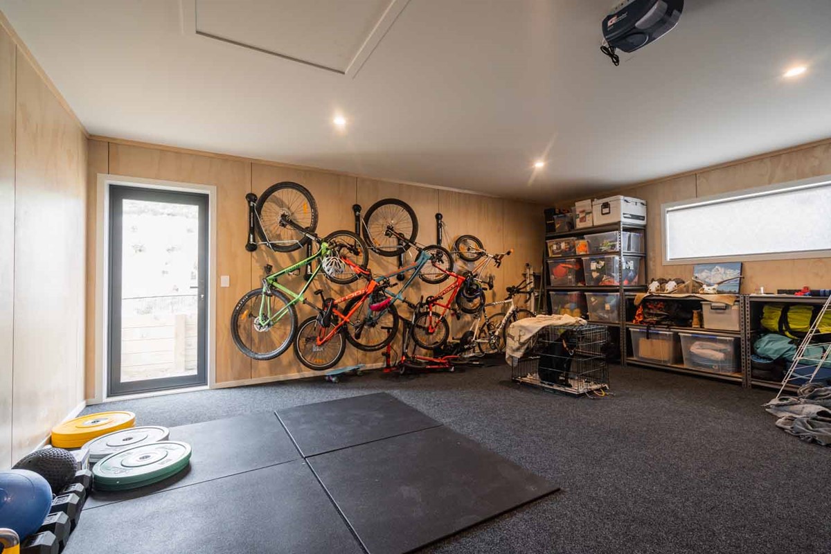 Kasey & Sindre are both Chiropractors in their area so a garage with a small gym area suits them perfectly. The family bike rack is a great use of space hanging from the wall and reducing clutter from the floor area.