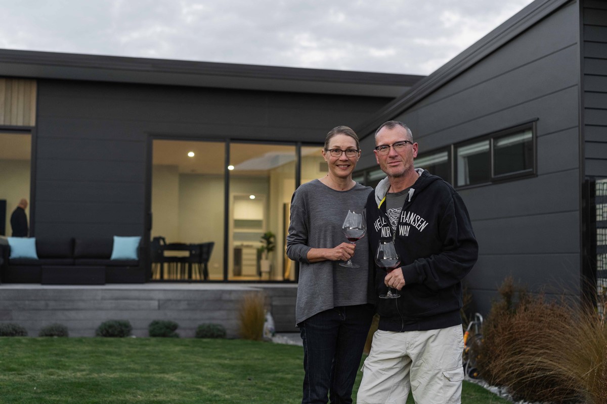 Greg and Suzanne featuring a glass of Pinot as they take us out towards the platform in the garden. Suzanne describes watching the sun set out over the infinity lawn as another feature she loves about her and Greg's new home.