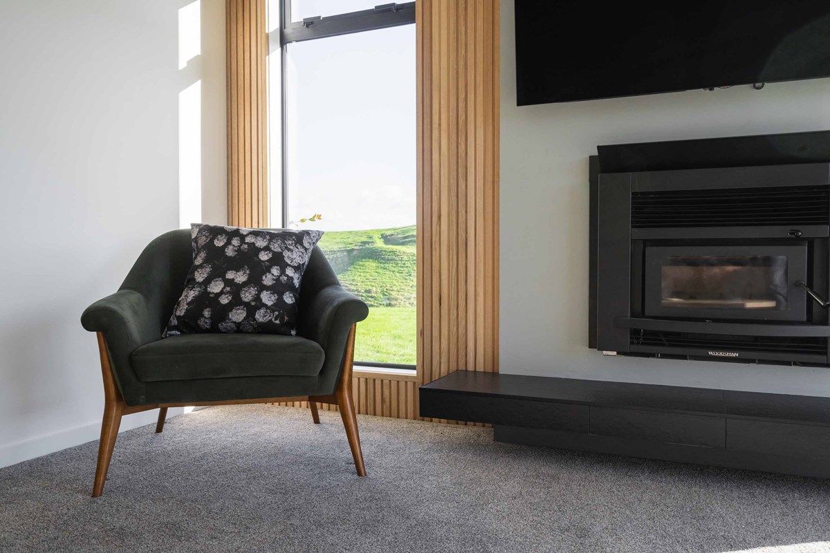 The lounge is one of Shaun's favourite places in their home. He enjoys sitting on the couch with the fire going and watching TV in this cozy setting.