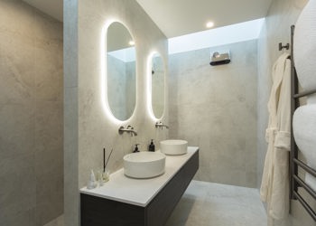 Modern Ensuite With Twin Vanities And Oval Mirrors